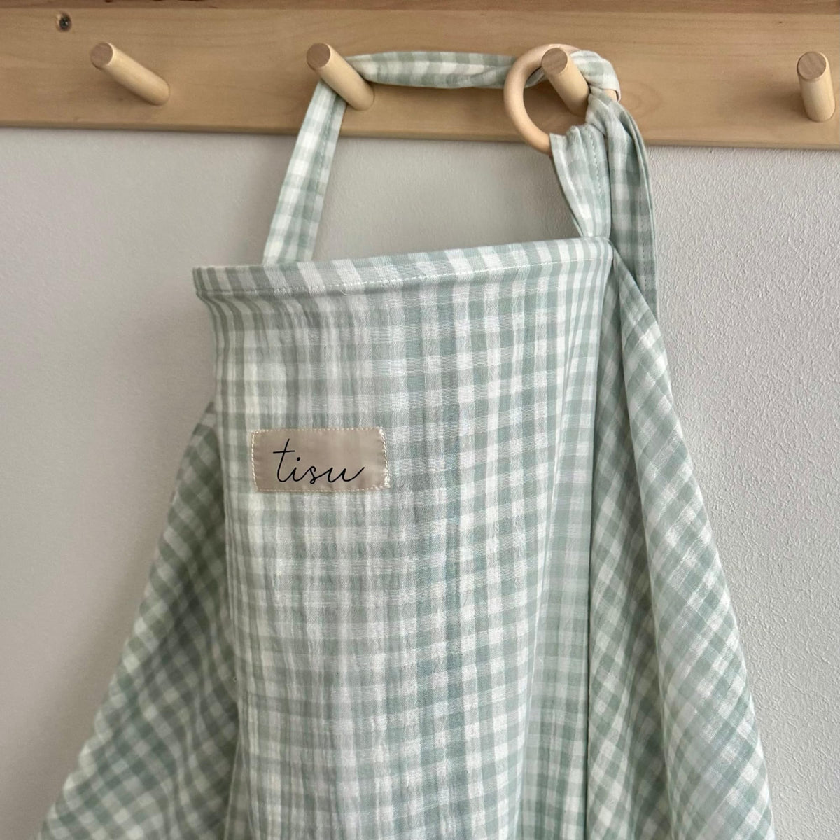 TISU nursing cover enables discreet breastfeeding with arch neckline and airflow.