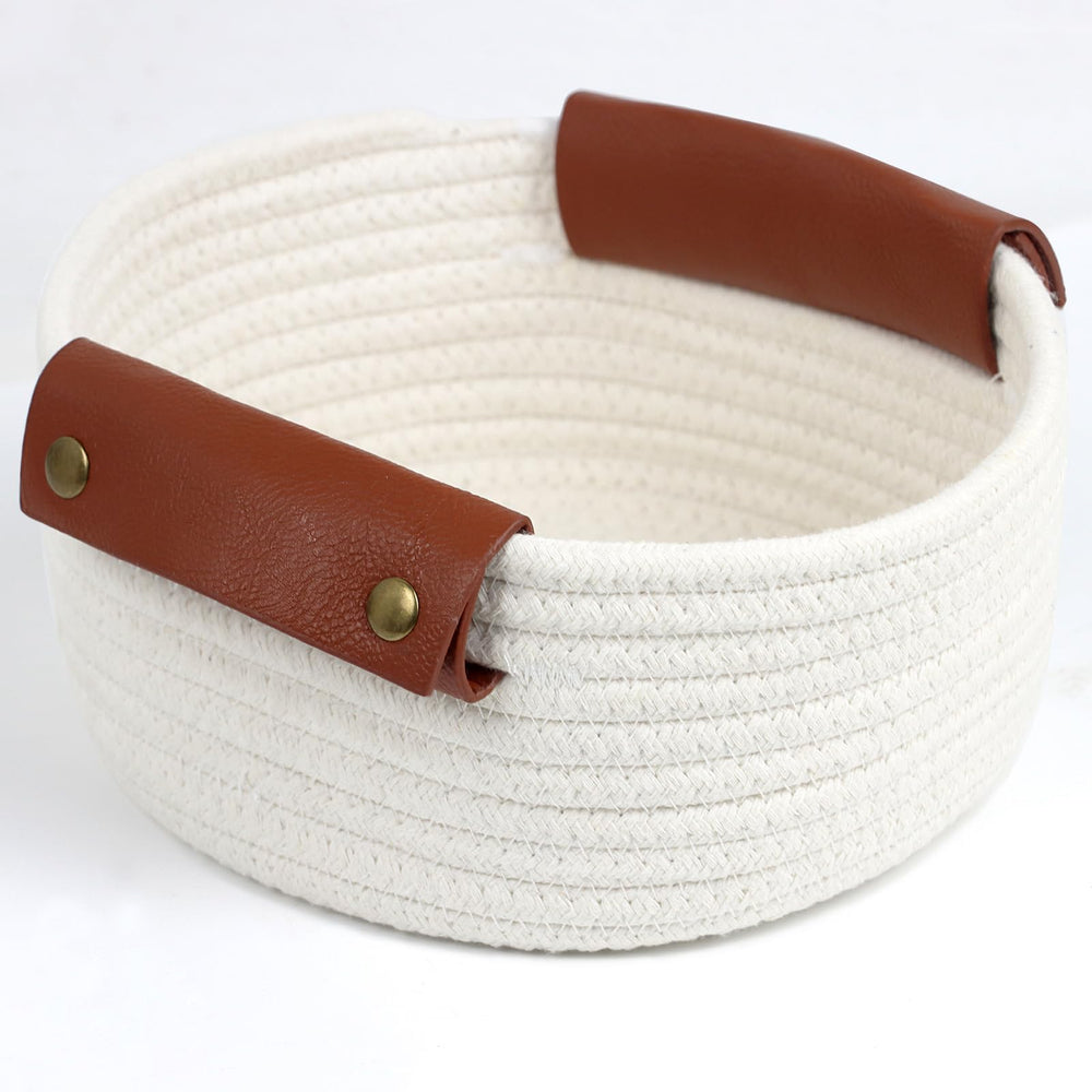 Togous small round basket with wide leather handle for easy transport.