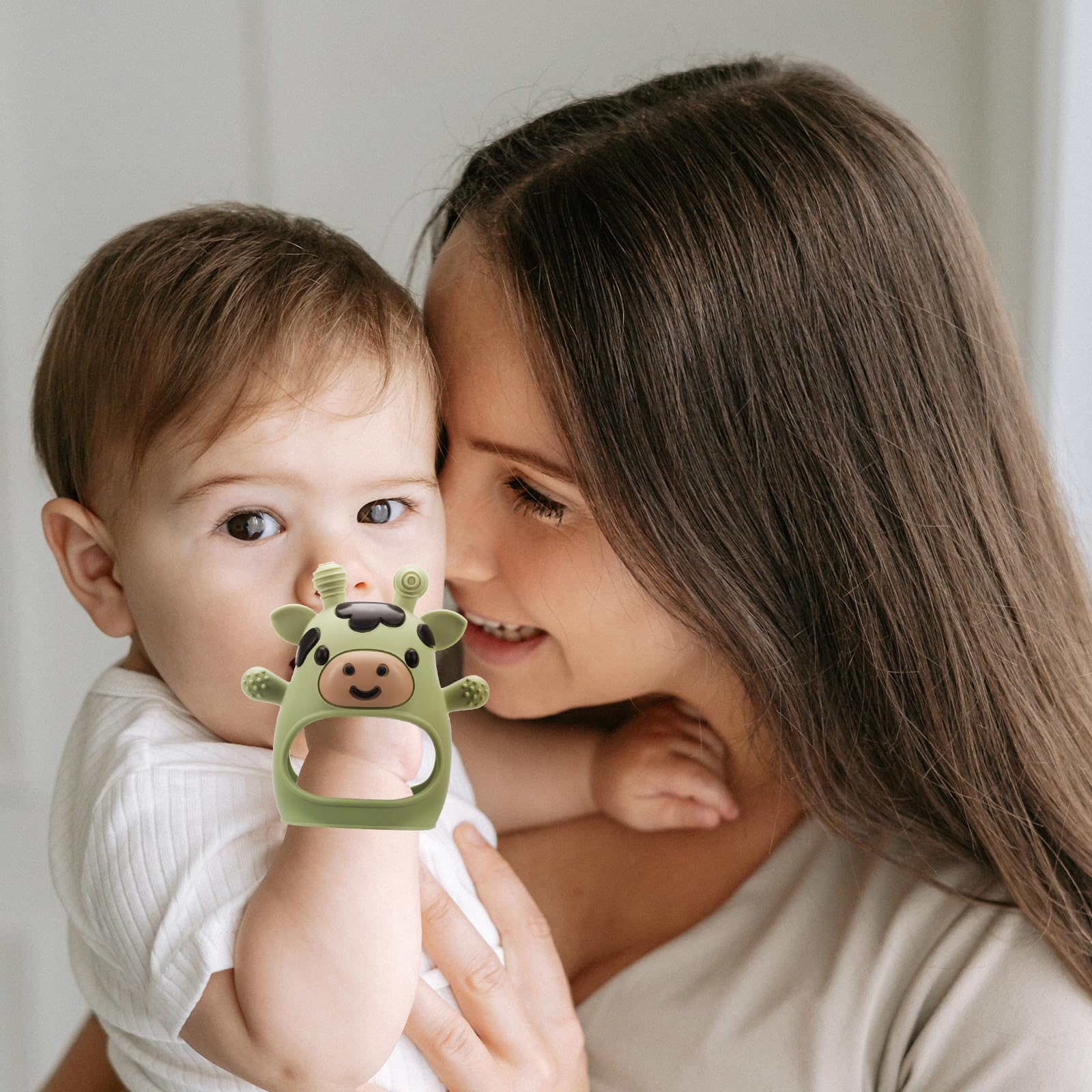 TOHIBEE teething mitten in hand for easier grip.