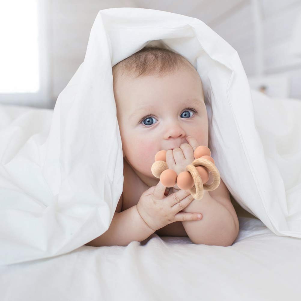 TOPGOMES teether apricot held by baby to support natural grasp