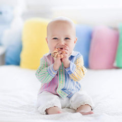 TopGOMES wooden beech teether held in small hands for a natural safe grip.