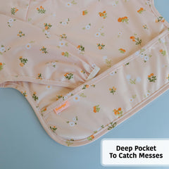 Torange smock bib shows adjustable neckline for a comfortable, growing-with-baby fit