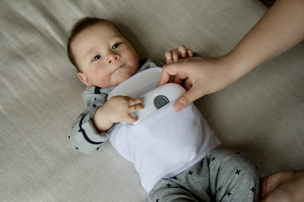 Tranquilo Baby Soothe wrap-around belly band keeps massager in place.