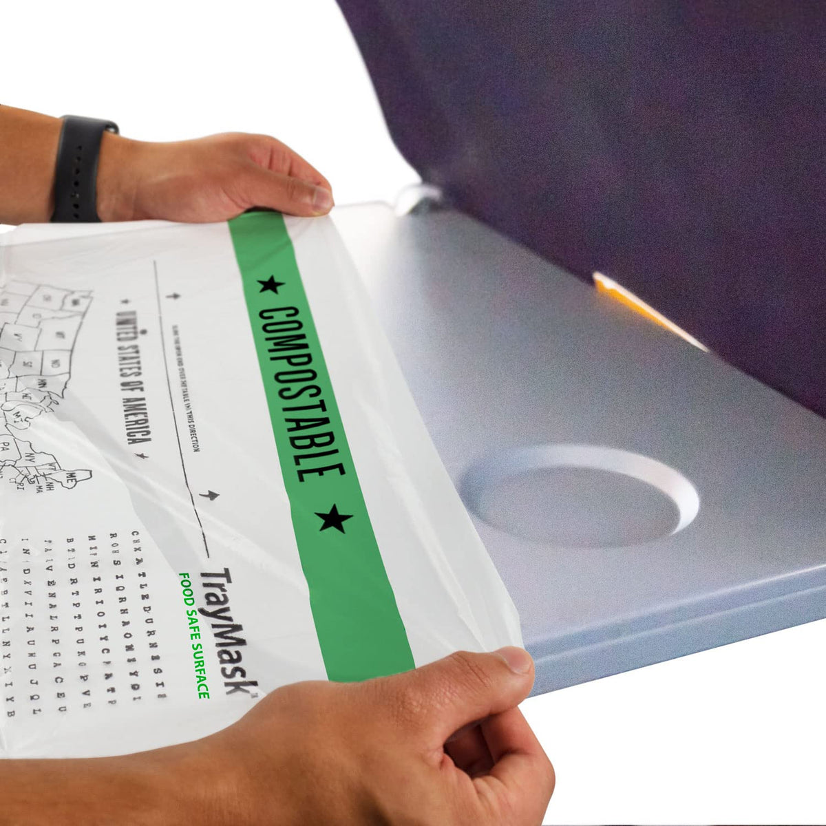 TrayMask compostable tray table cover on airplane tray keeps surfaces clean