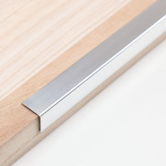 Trimold aluminum peel-and-stick L-molding corner guard protects 90° walls.