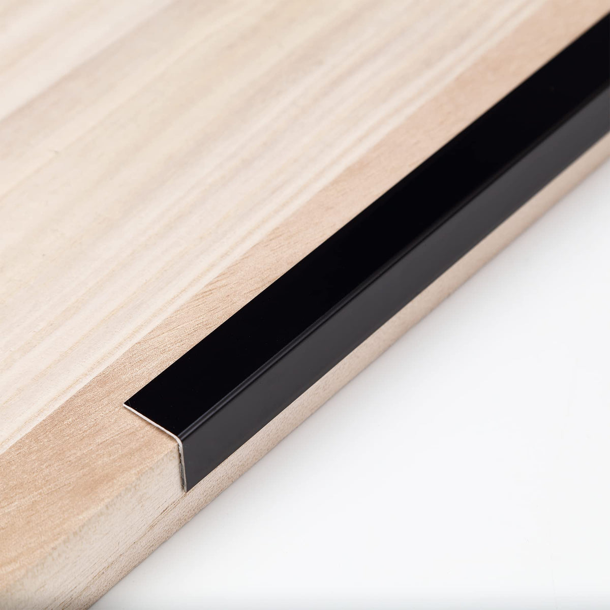 Trimold aluminum peel-and-stick L-molding corner guard at 90°, protects wall corners from everyday bumps.