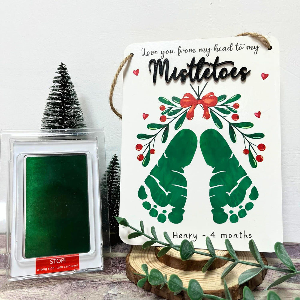 TRUMPETIC Mistletoe footprint art crafted for holiday memory keepsakes.