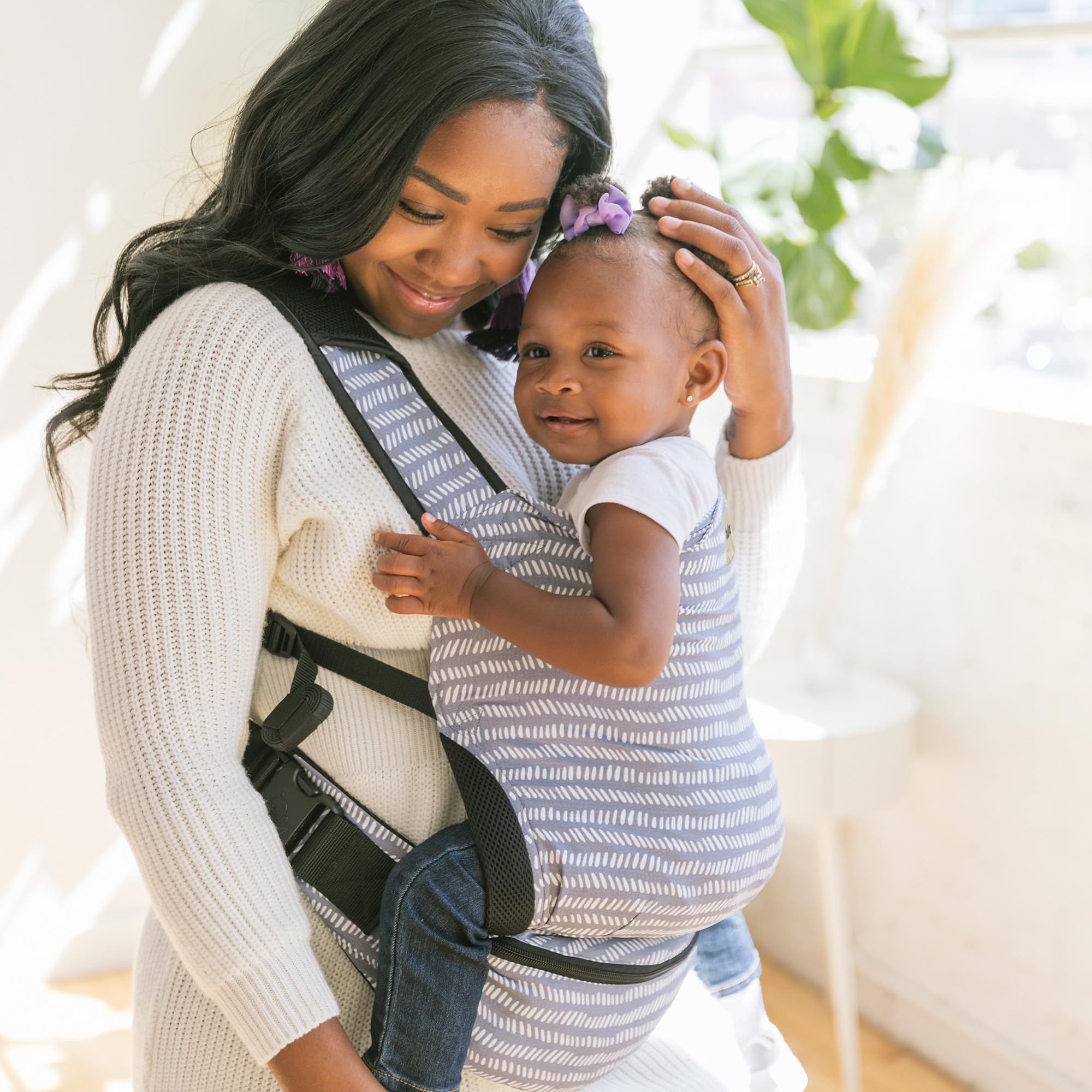 Tula Baby Lite removable UPF 50+ hood offers sun protection.