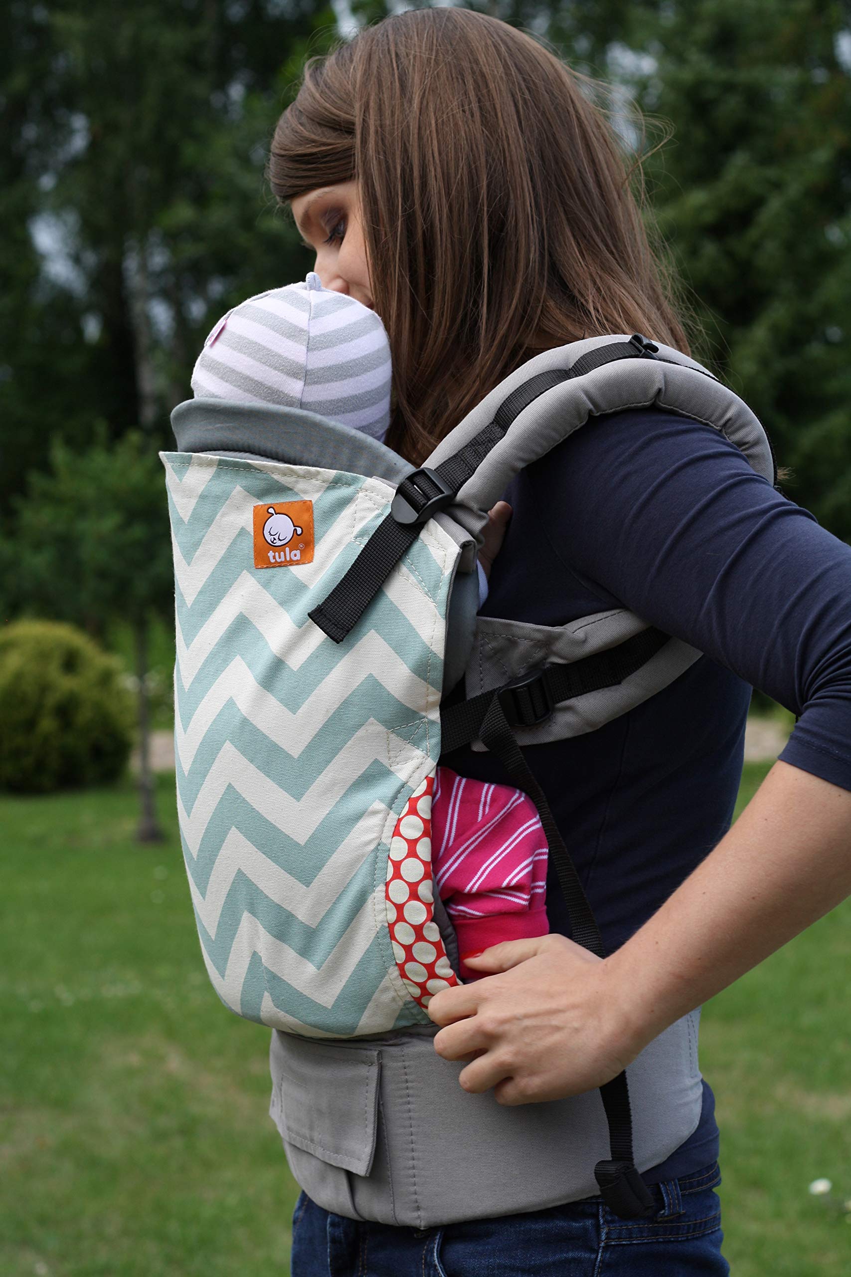 Tula infant insert demonstrates secure harness and ergonomic positioning for newborns.