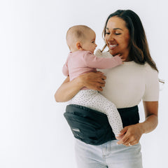 TushBaby hip-seat carrier assembly demonstrates easy setup for on-the-go parents.