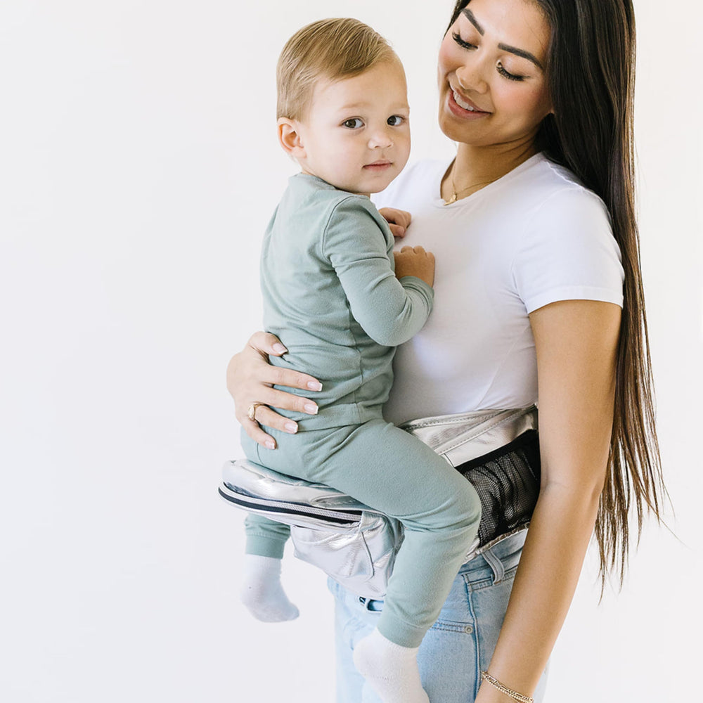 Nursing pillow attachment demonstrates hands-free feeding on the go.