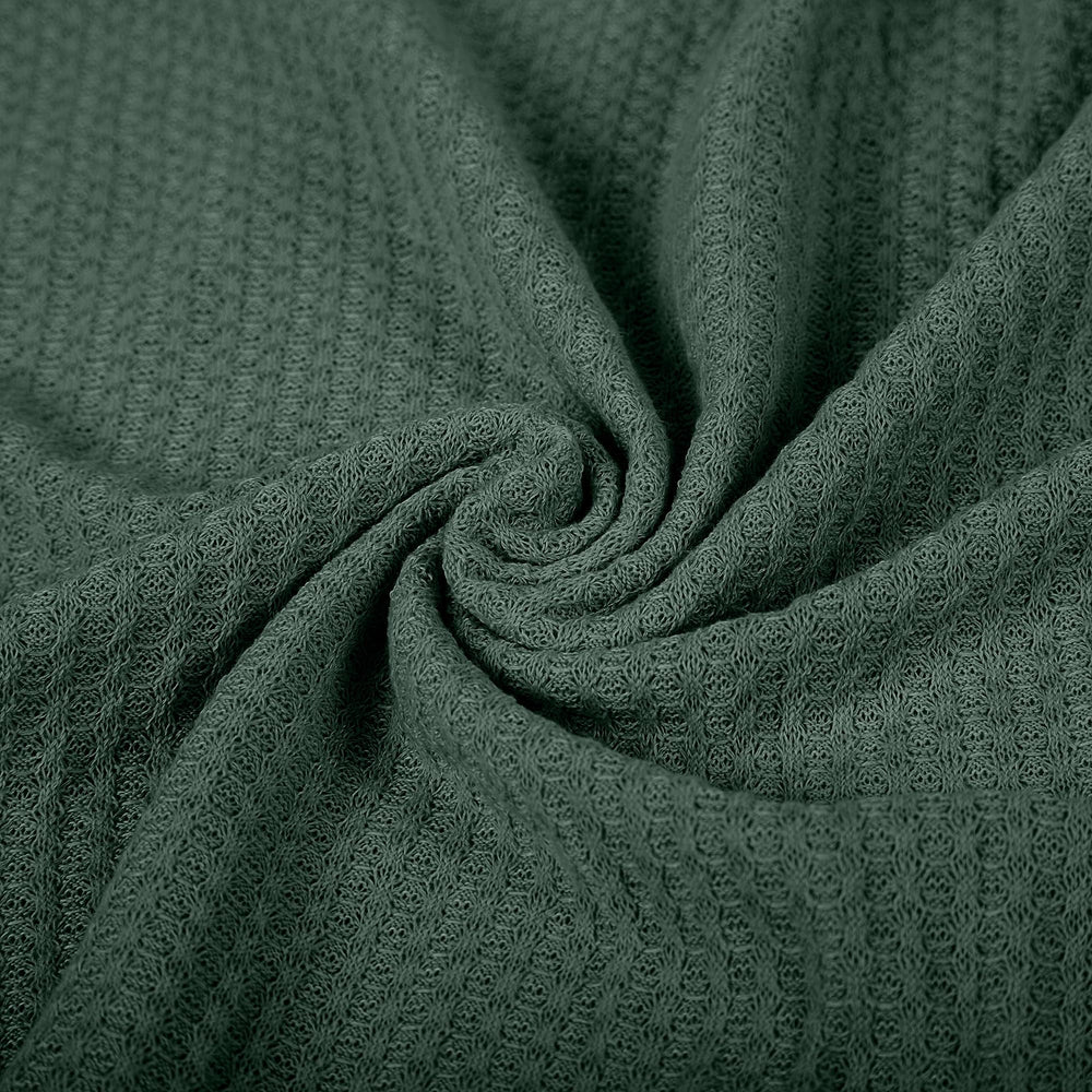 Twinkle Nest dark green wrap in a photography setup with gentle lighting