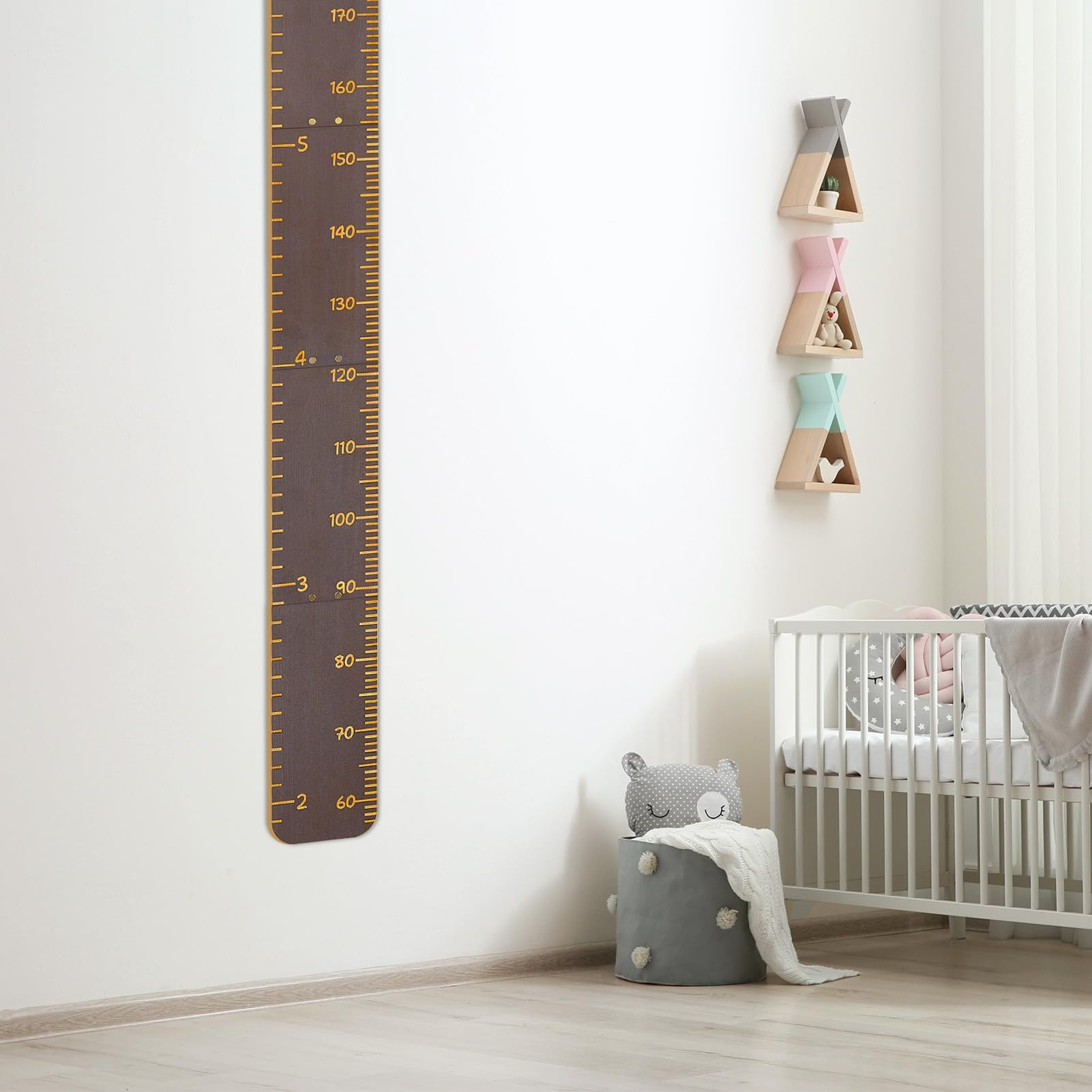 Nursery decor enhances kid's room with Unicorn Castle height chart on wall