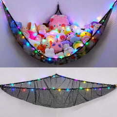 Unicorn Castle hammock with stuffed animals in a kid's room for tidy storage.