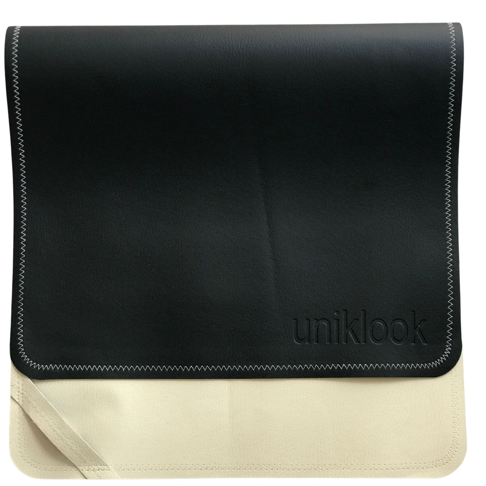Uniklook portable changing pad in black cream vegan leather, ideal for travel diaper changes.