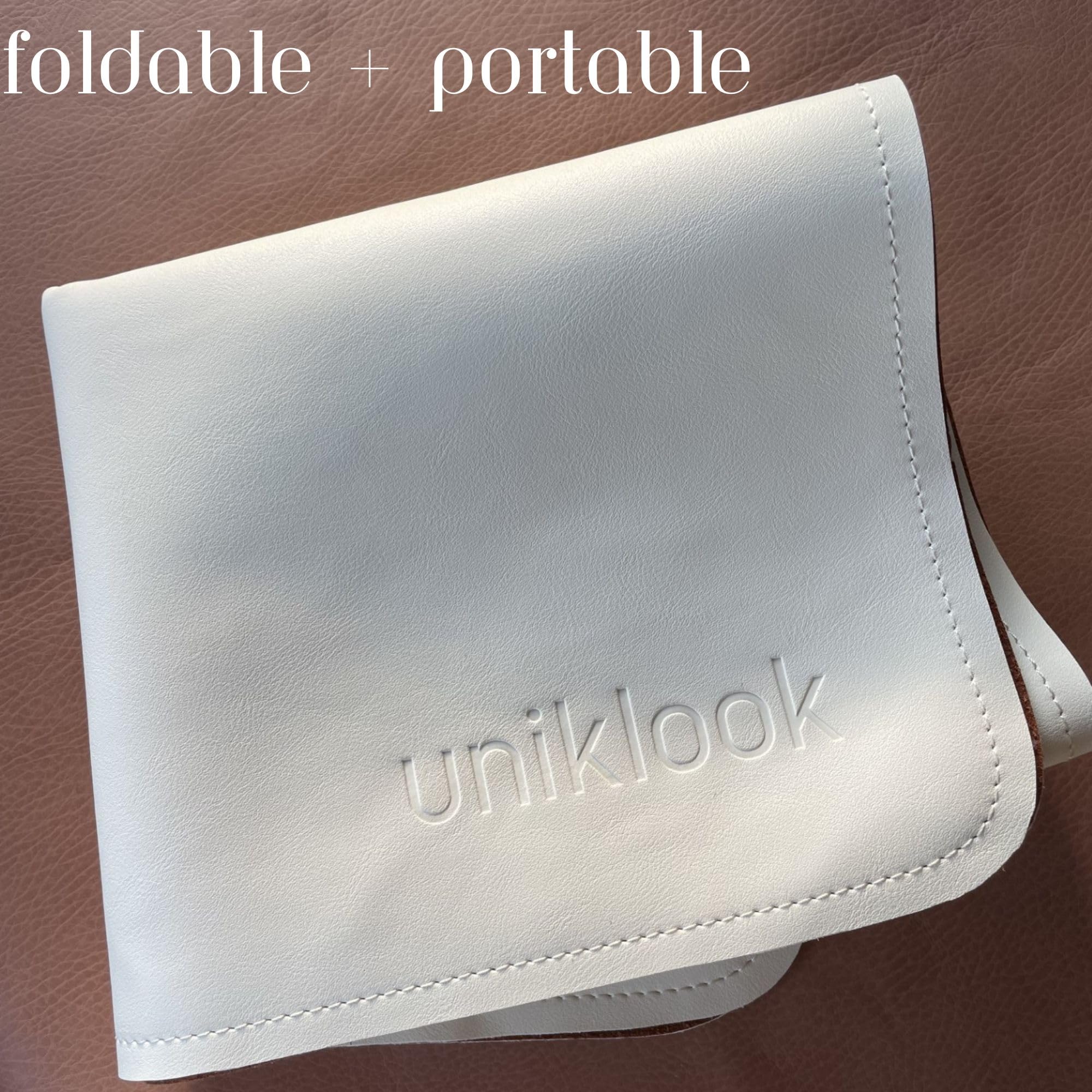 Uniklook travel-friendly changing pad fits bags, strollers, and backpacks.