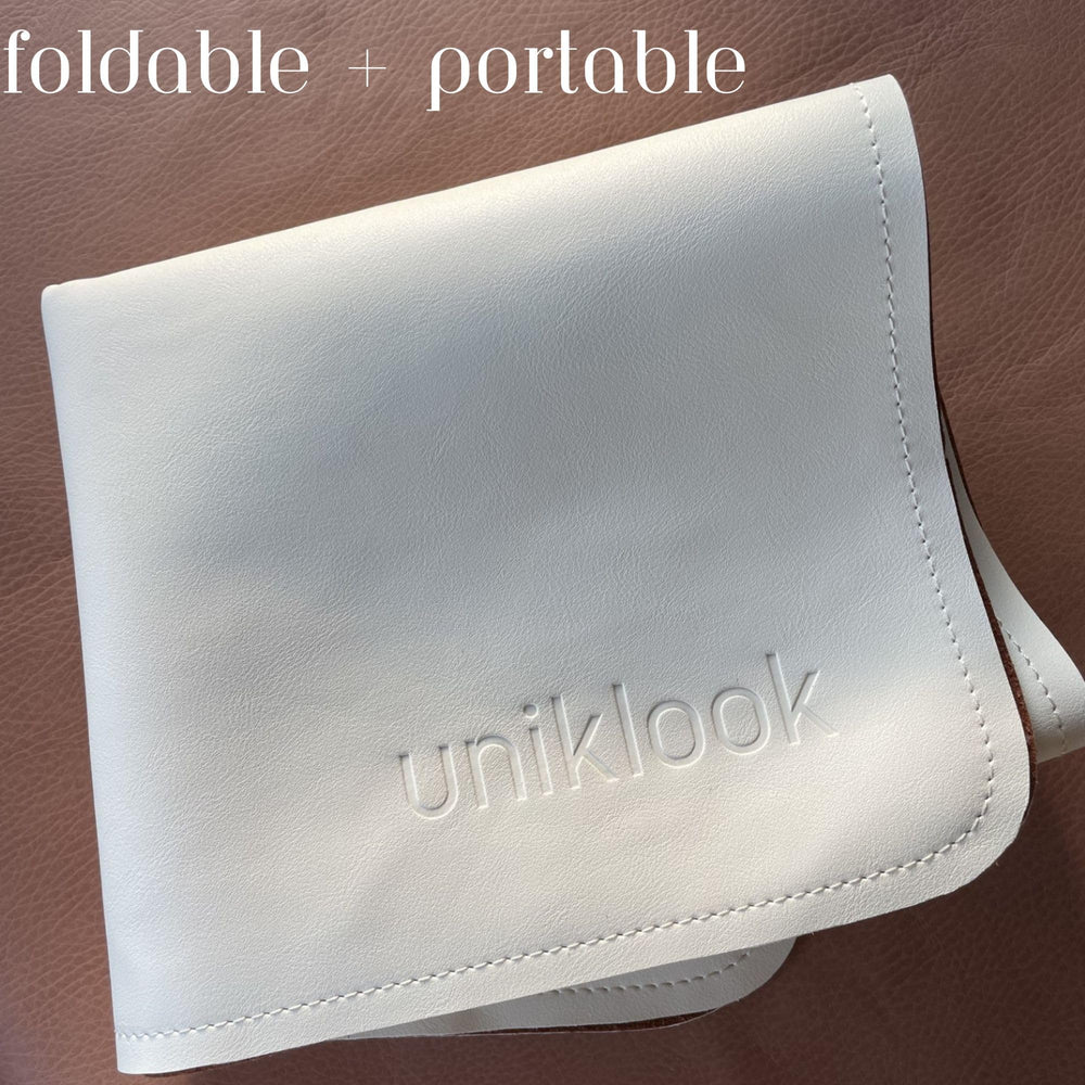 Uniklook travel-friendly changing pad fits bags, strollers, and backpacks.