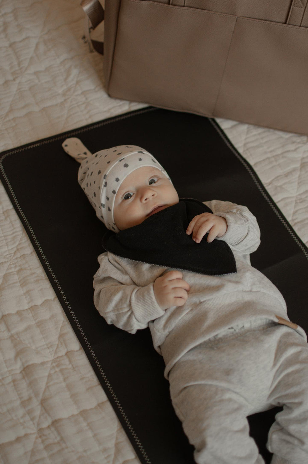 Uniklook waterproof foldable diaper station keeps surfaces clean on the go.