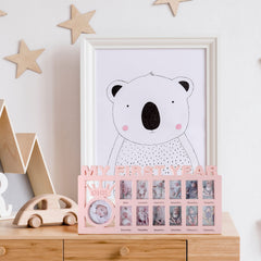 Unittype pink baby frame for wall display in nursery.