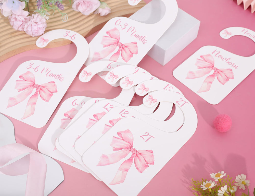 UOAOU bow-nursery-closet-divider-pink shown with hangers for easy organization.