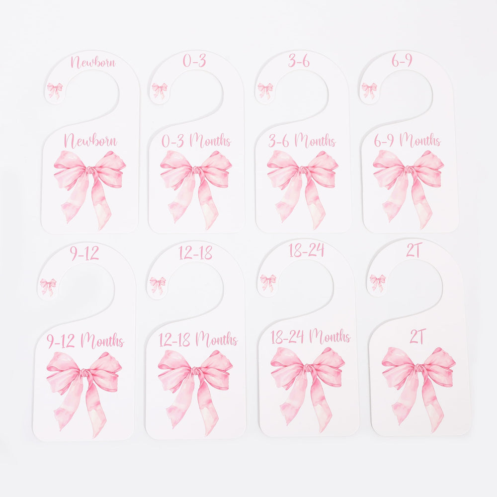 UOAOU bow-nursery-closet-divider-pink adds soft color to nursery décor and organization.
