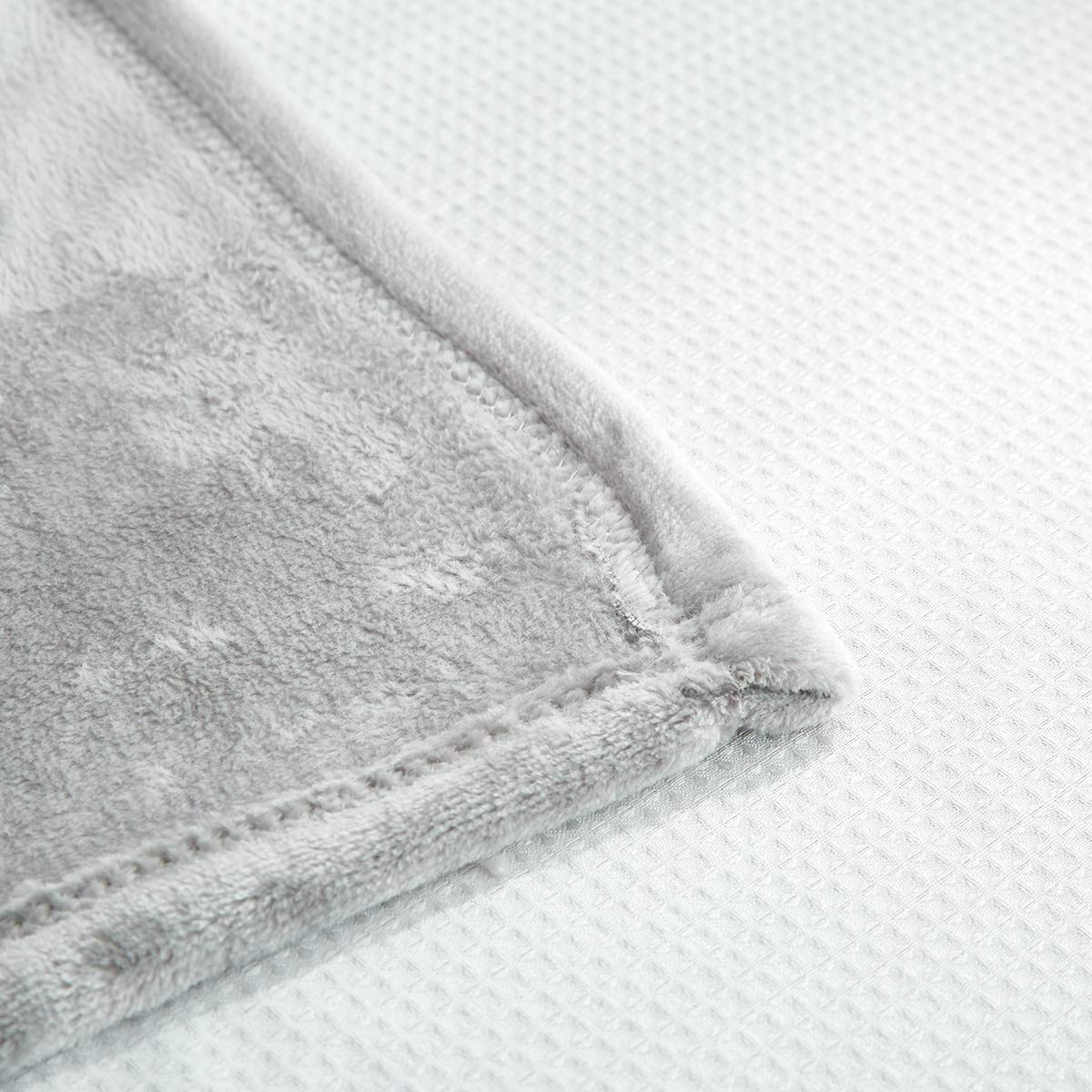 UOZZI BEDDING compact travel-friendly blanket shown folded for easy packing