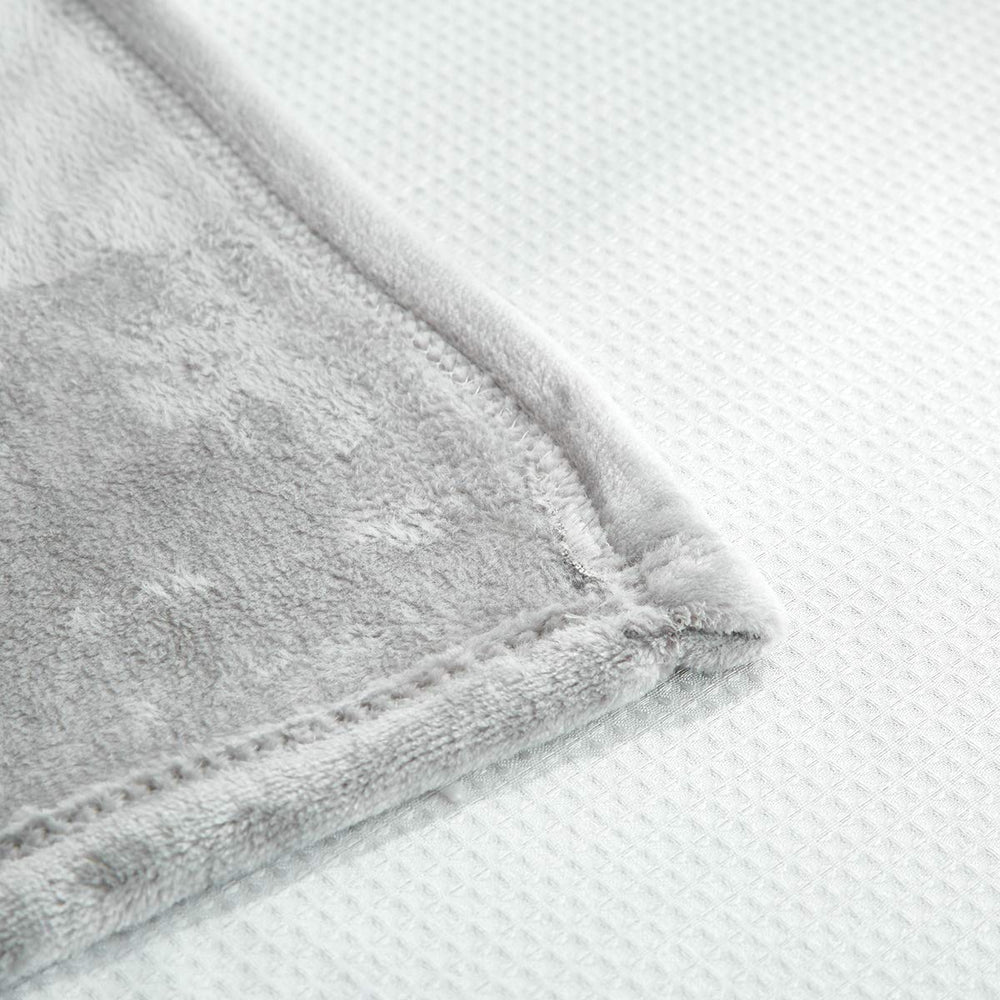 UOZZI BEDDING compact travel-friendly blanket shown folded for easy packing