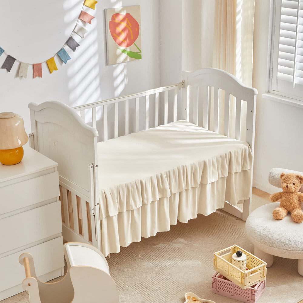 UOZZI BEDDING crib skirt 28x52 fits for a neat finish.
