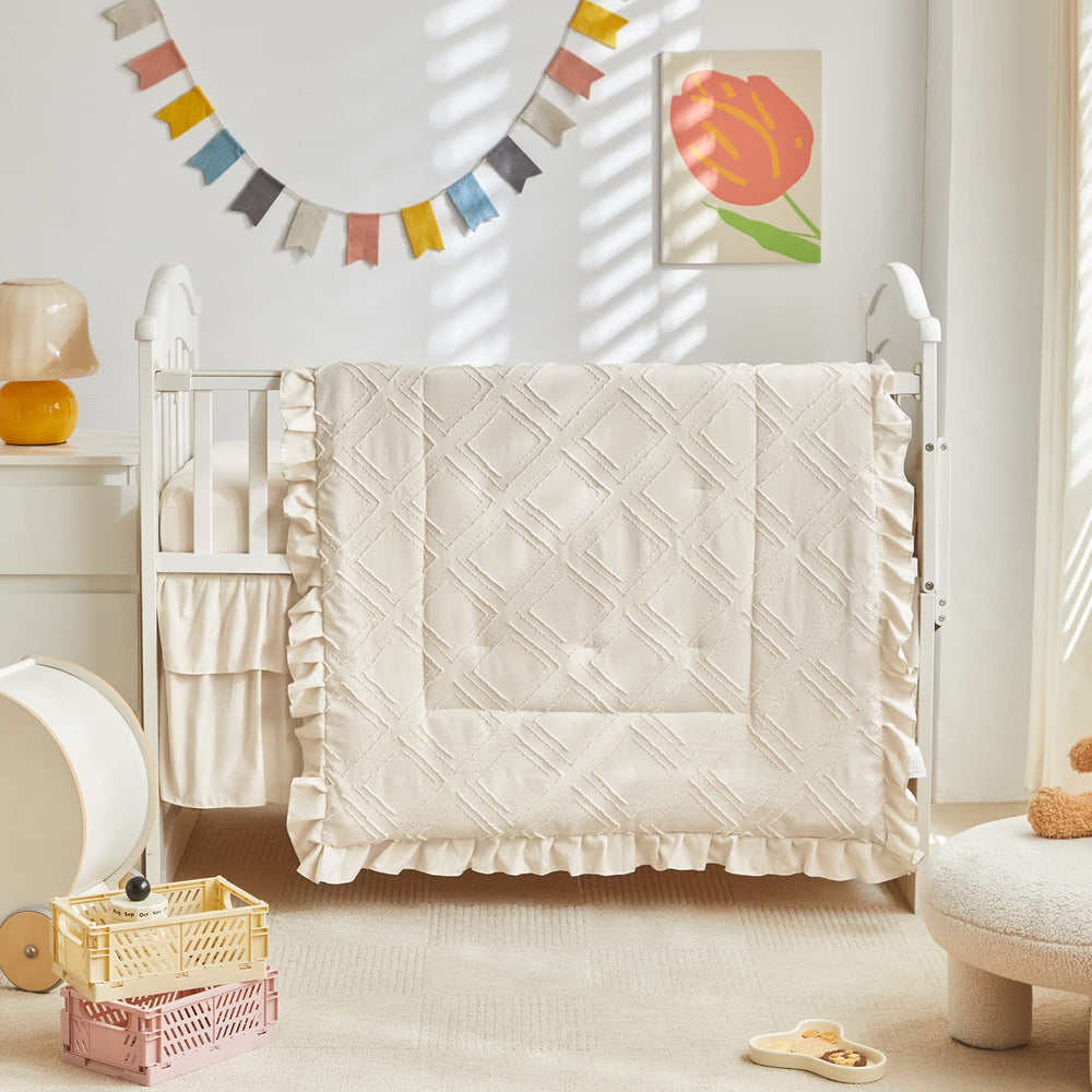 UOZZI BEDDING embroidery tufted detail enhances nursery texture.
