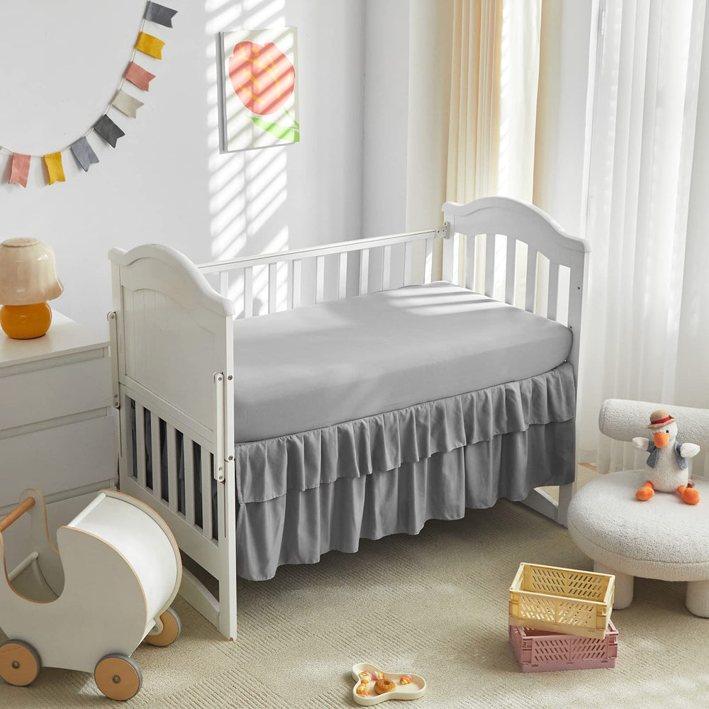 Gray crib bed skirt complements nursery decor