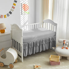 Gray crib bed skirt complements nursery decor
