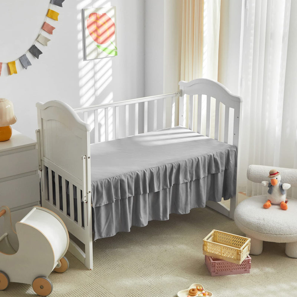 Three-piece crib bedding set: comforter, sheet, and skirt