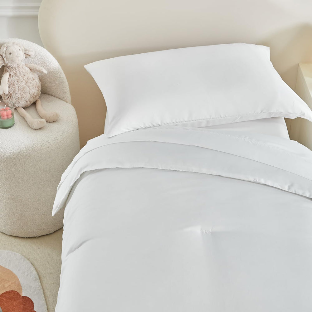 UOZZI BEDDING white bed scene shows clean, versatile nursery styling