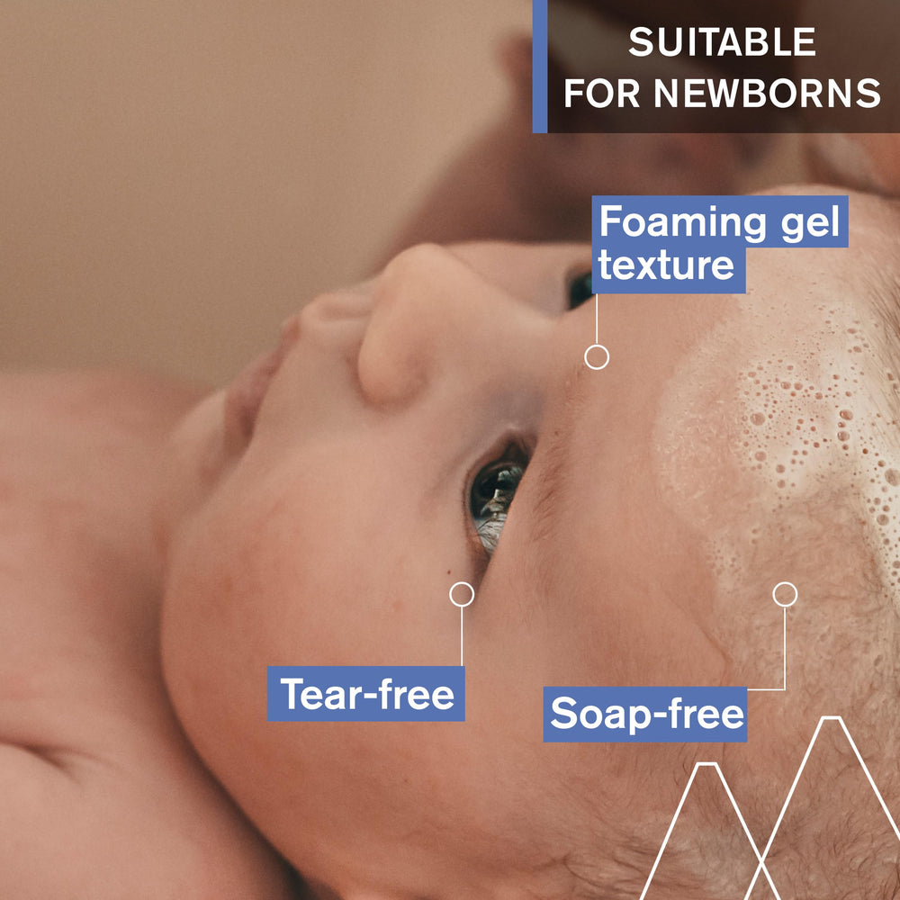 Uriage Baby 1st Shampoo bottle being poured into hand for lathering.
