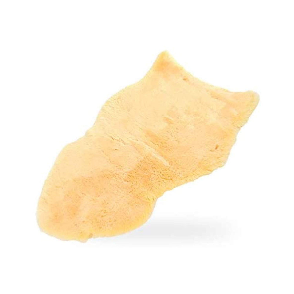 US Sheepskin Medical Pelt Pad laid flat on a bed showcasing a large size for bedsores comfort.