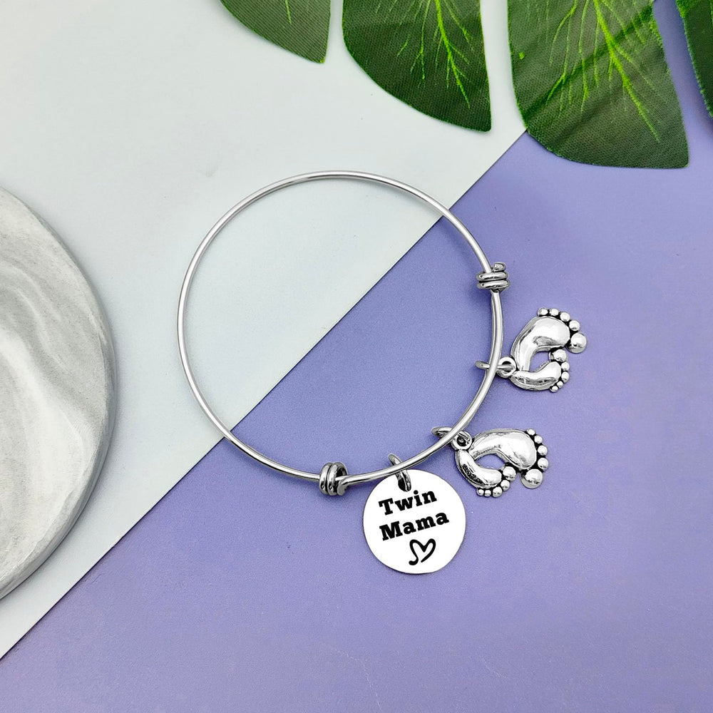 Vadaka Twins Mama Jewelry used for pregnancy or gender reveal moment.