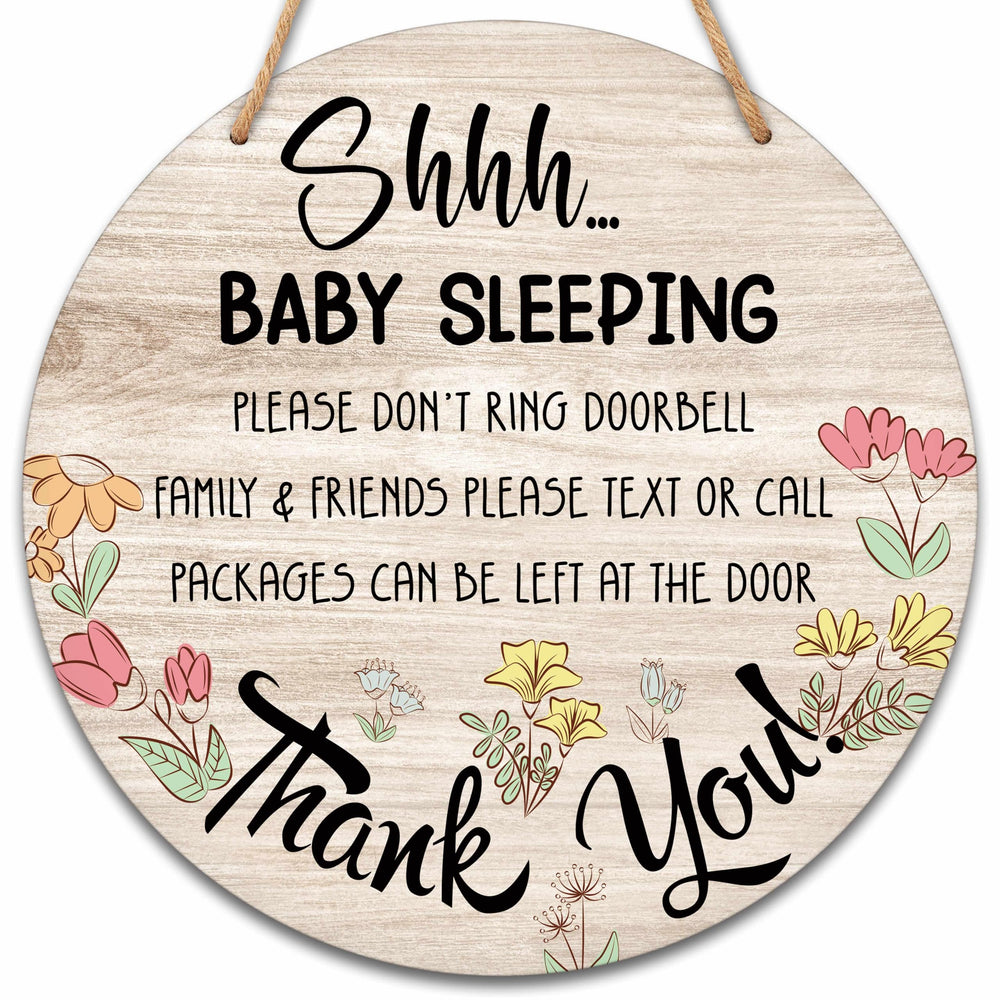 Valucise baby sleeping sign on front door showing rustic round wood decor.
