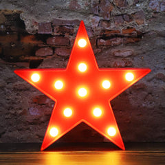 Vicila LED Marquee Star Sign red on wall emits warm cozy glow.