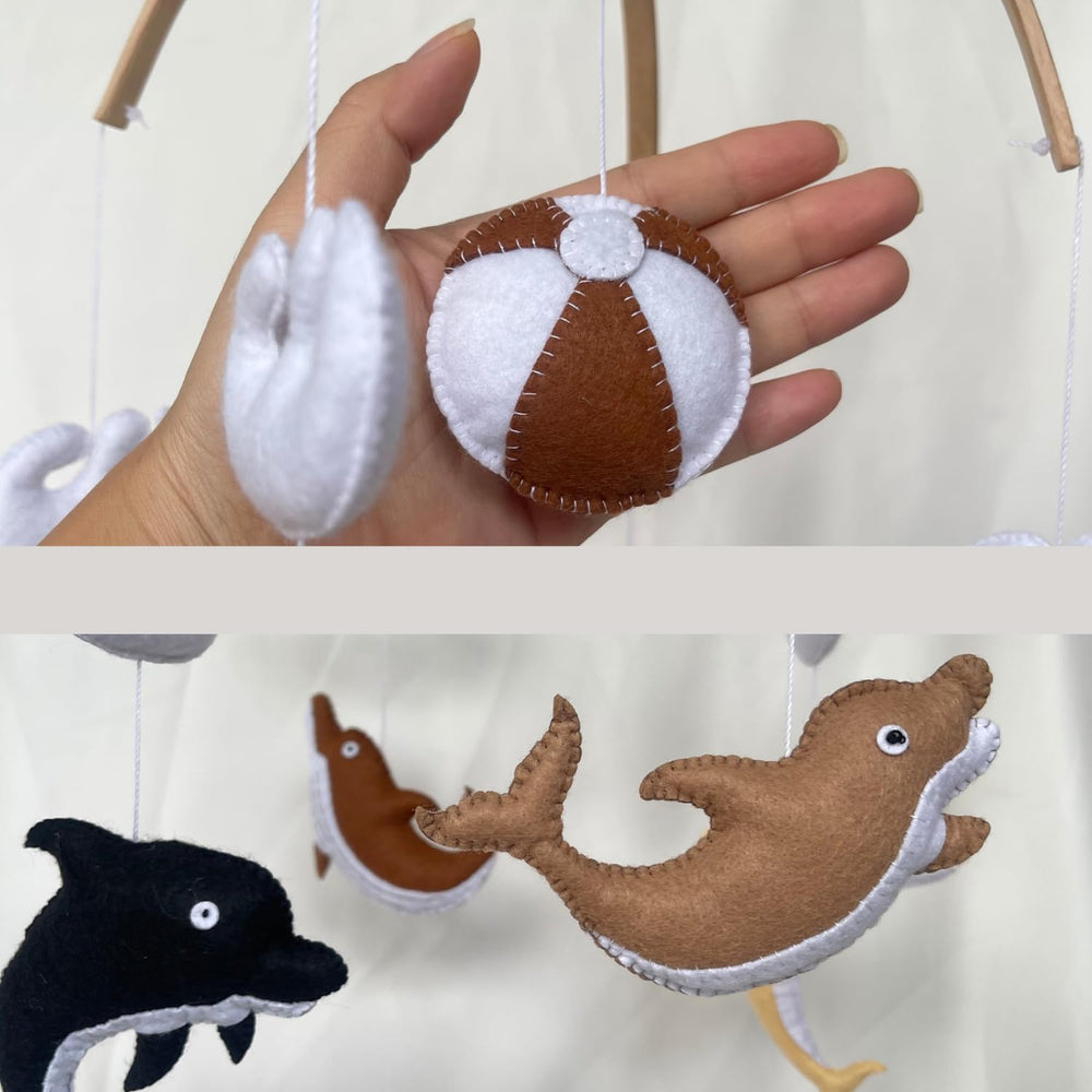 VN3BTOY Handcrafted dolphins and beach-ball accents create a visual focal point in any nursery.
