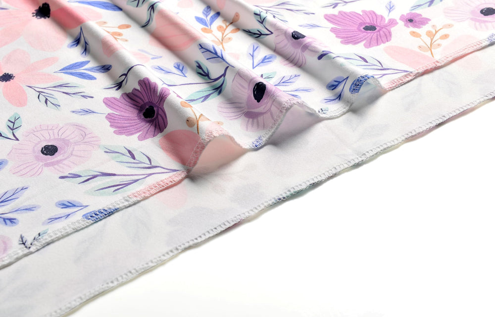 Vollmic swaddle blanket features serged edging for durability.