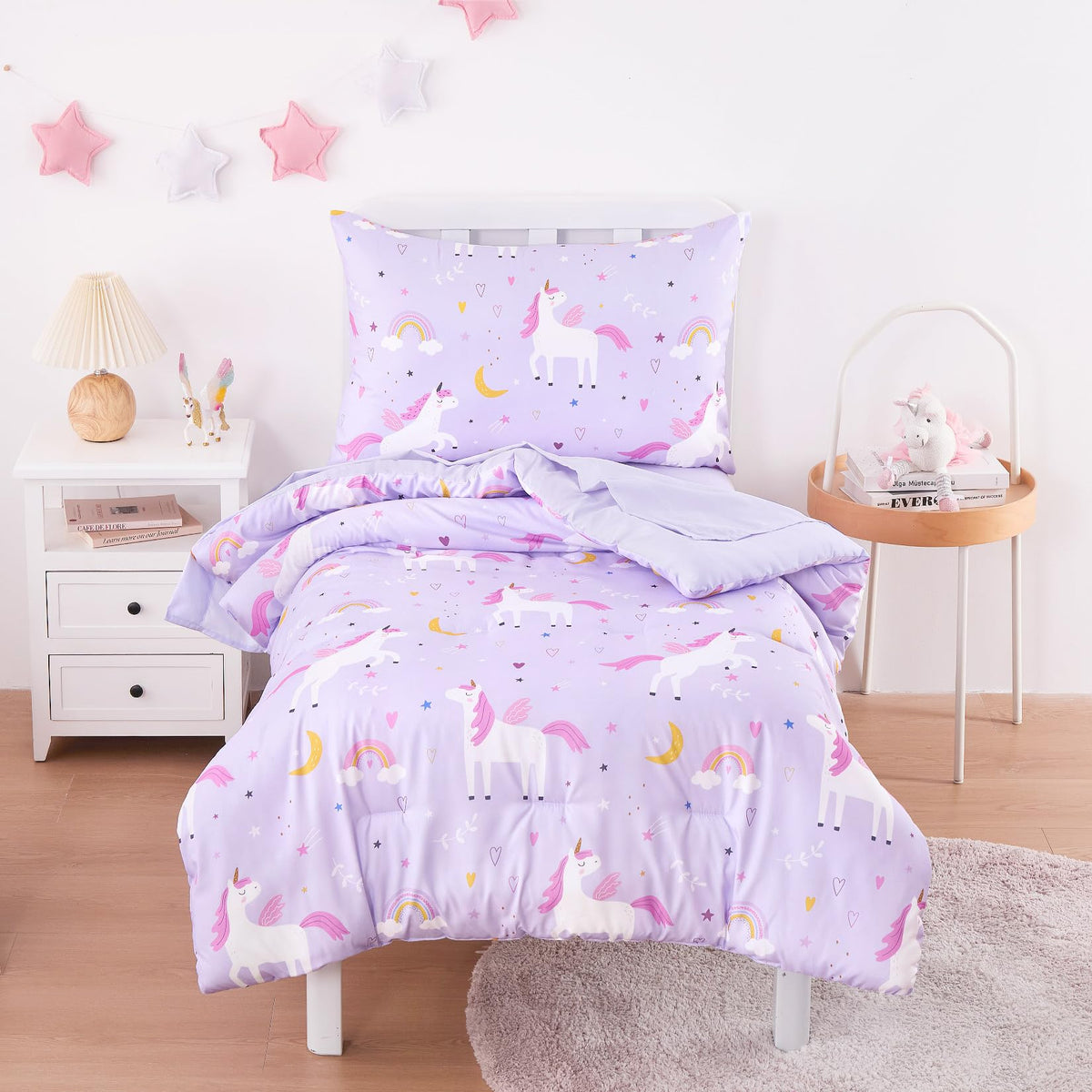 Wake In Cloud 4-piece bedding set on toddler bed featuring unicorn rainbow stars.