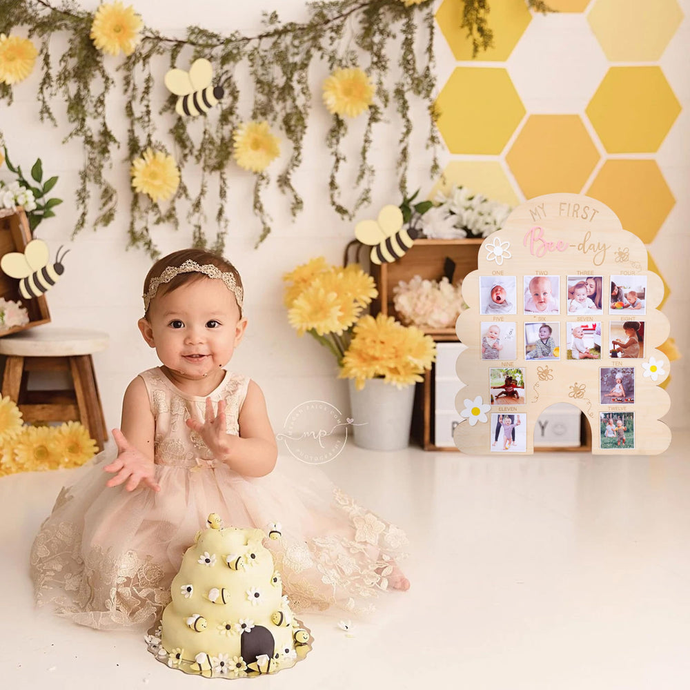 WAOUH First Year Bee Photo Board highlights monthly growth in a natural wood finish.
