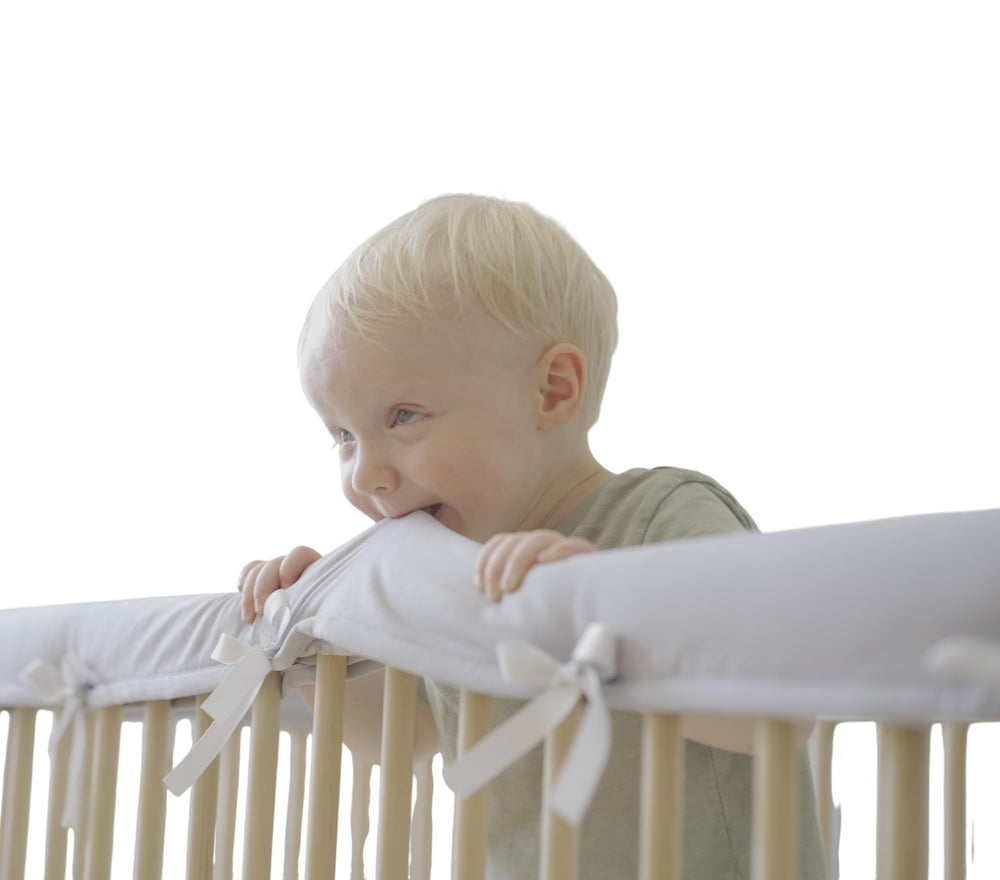 Wazzo crib rail edge cover front view shows soft cotton protection for teething babies
