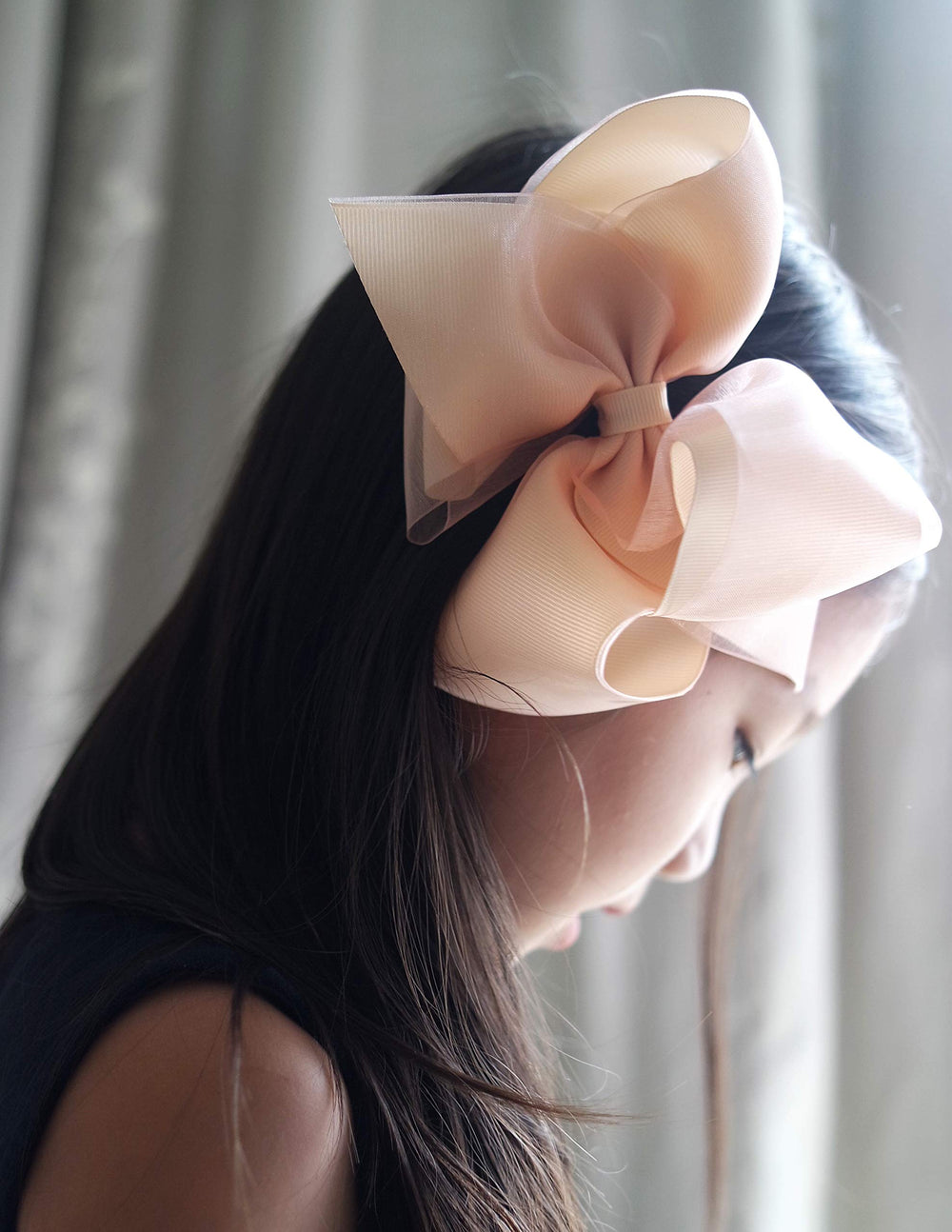 Bow worn on a child’s hair for everyday casual or dressy looks.