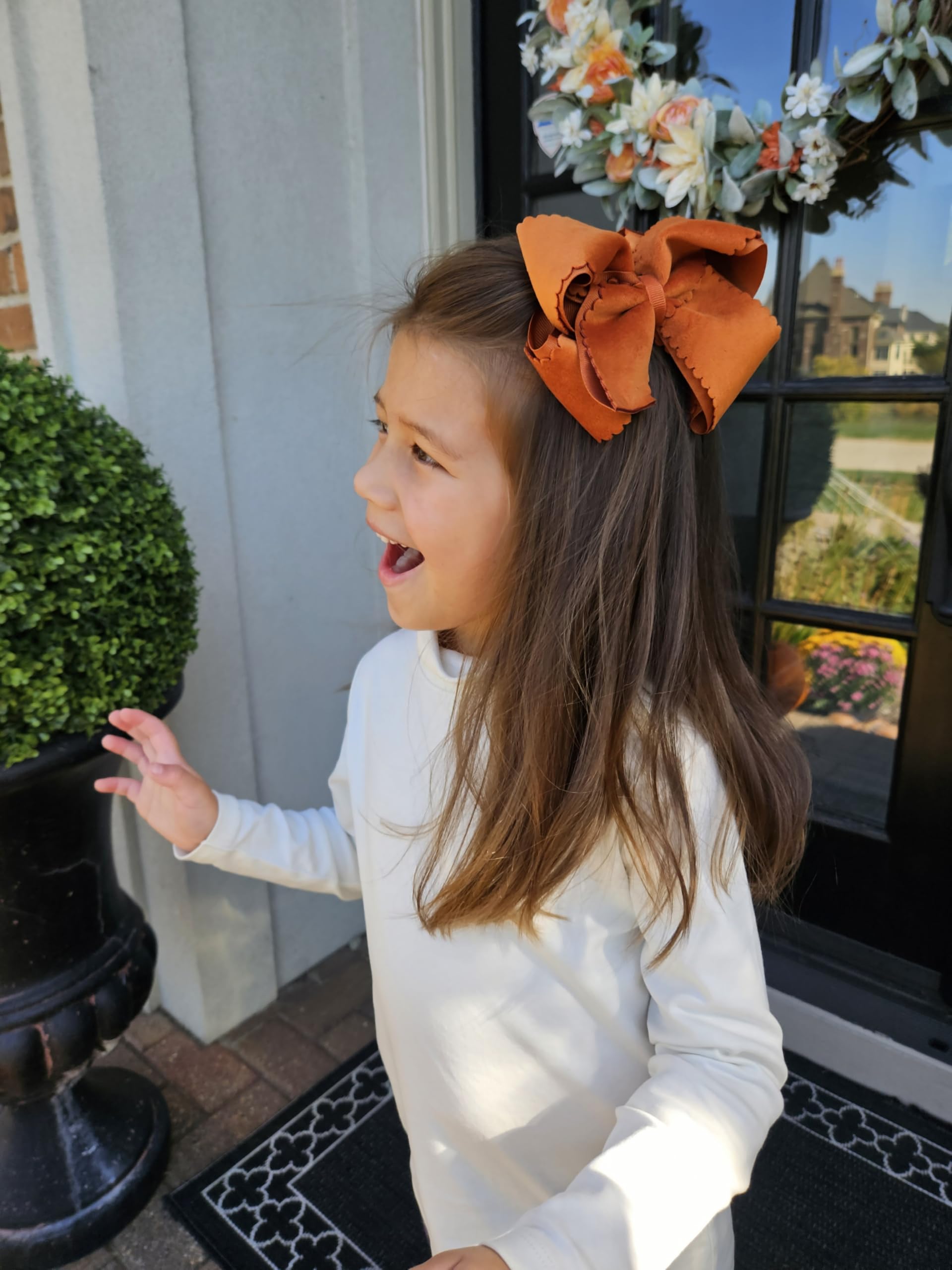 Wee Ones burnt orange bow worn by a child for versatile daily outfits