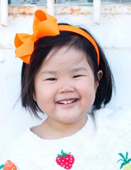 Wee Ones close-up shows red grosgrain texture and timeless styling.