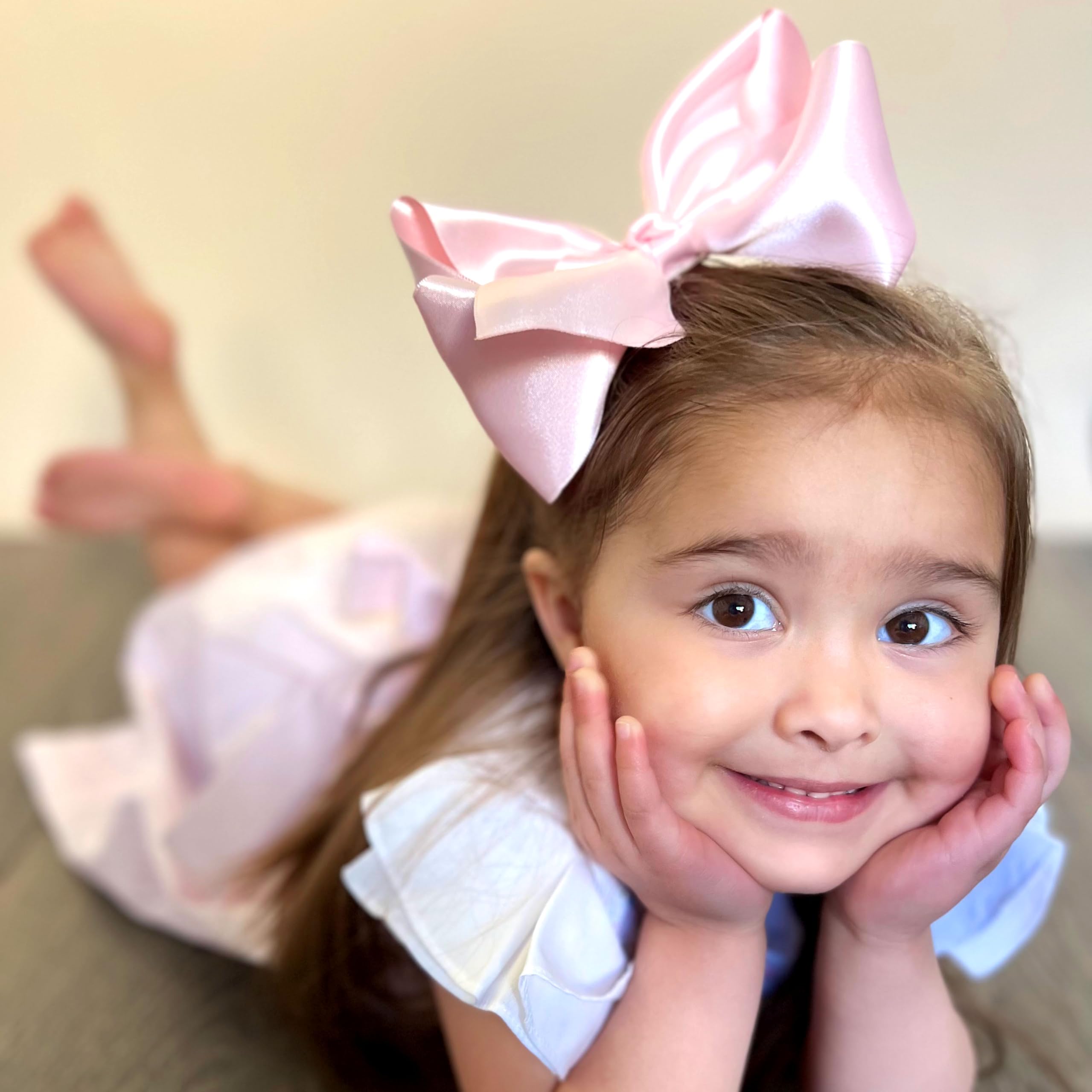 Wee Ones soft satin bow with secure clip for comfy all-day wear.