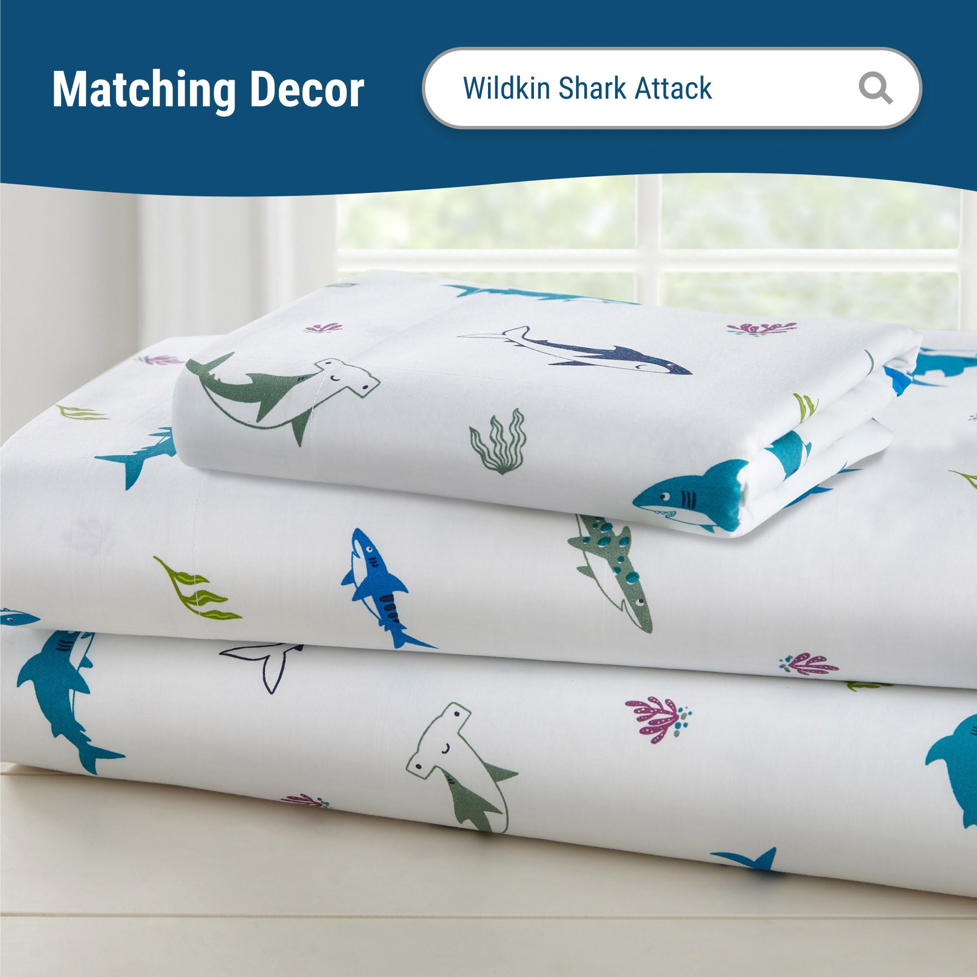 Wildkin 100% cotton crib sheet shown on a crib mattress