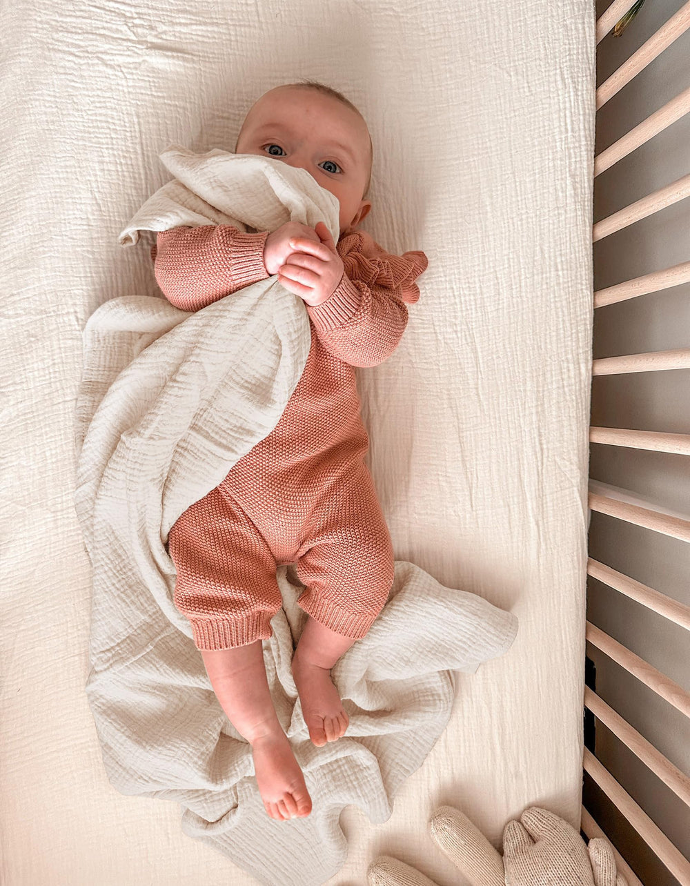 Wimist muslin swaddle blanket wrapped around baby for secure, cozy swaddling