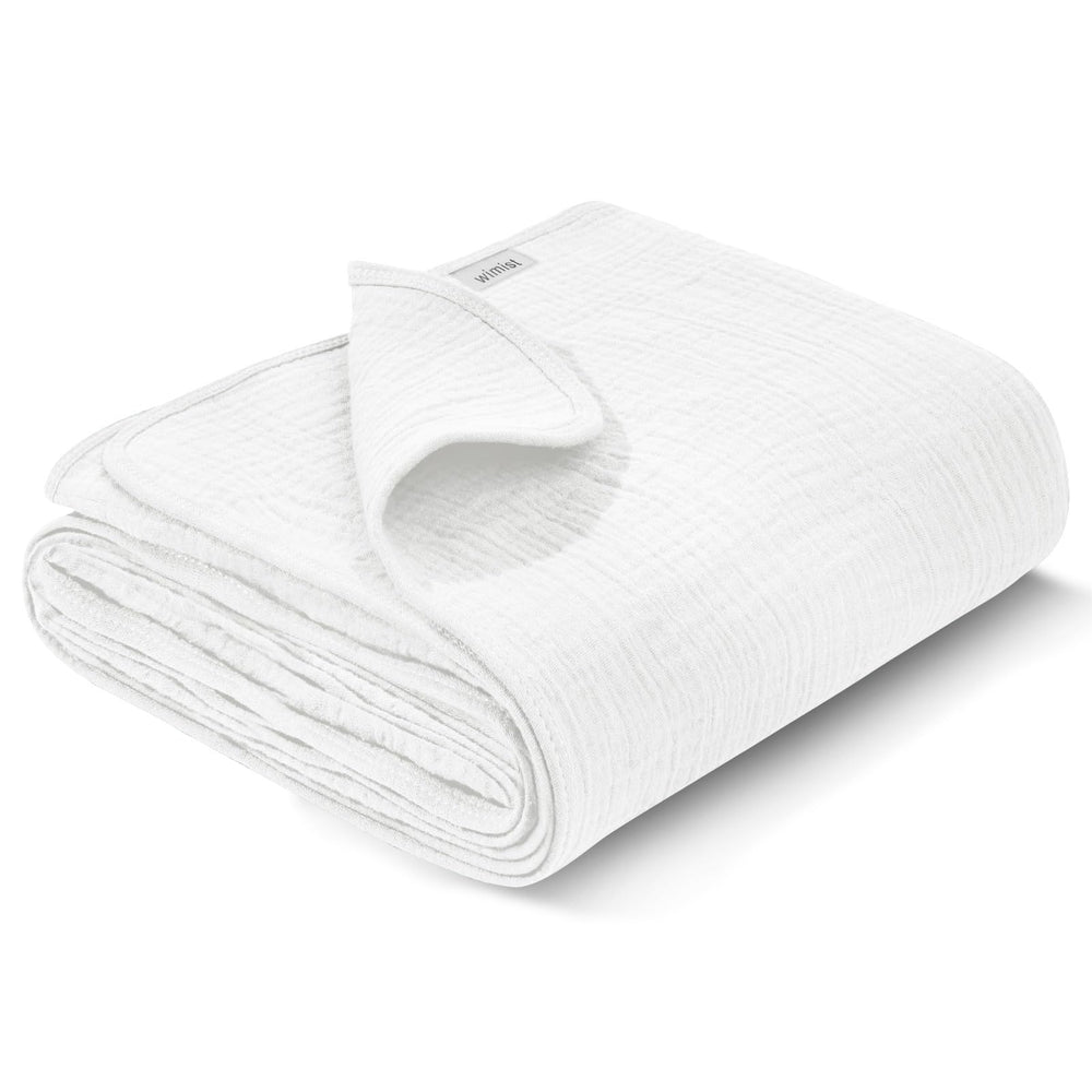 Wimist muslin swaddle blanket flat lay in white, showing versatile newborn care use